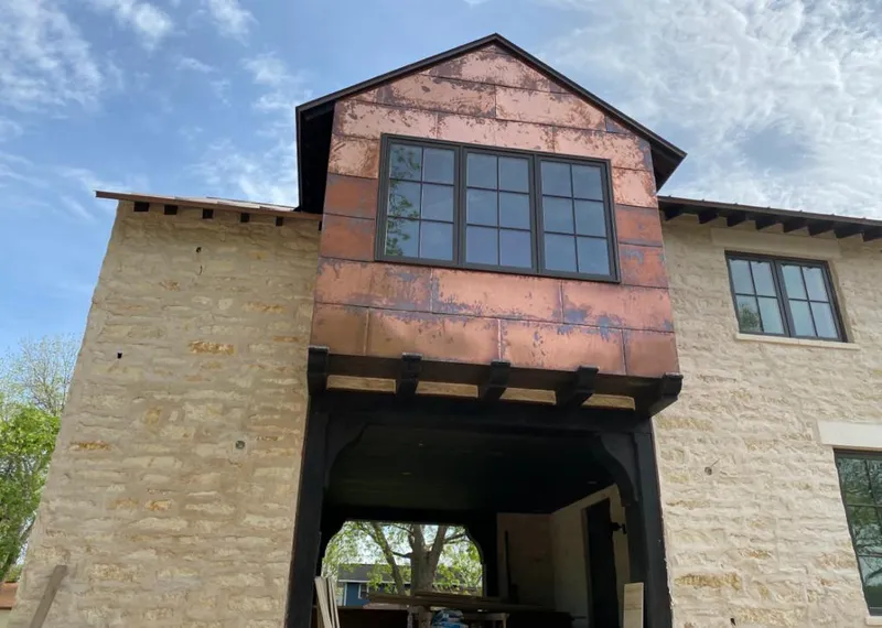 Copper metal panel facade on a stone building for Skylight Installation in Signal Mountain