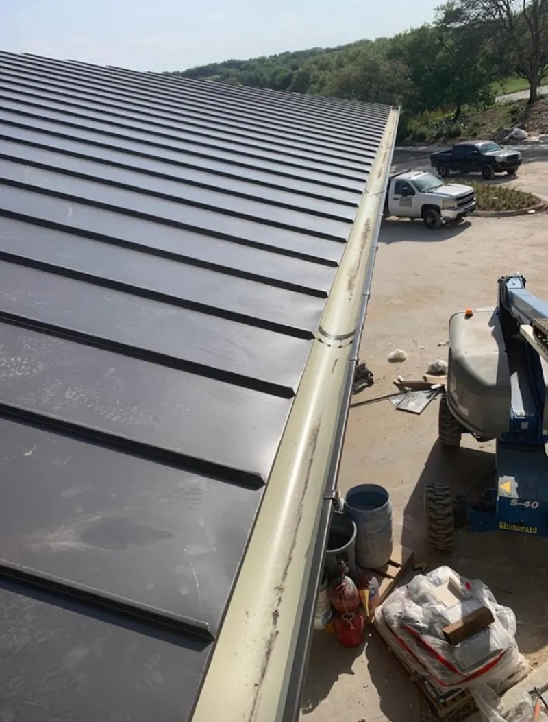 Standing seam panel and gutter detail on a metal roofing jobsite in Signal Mountain